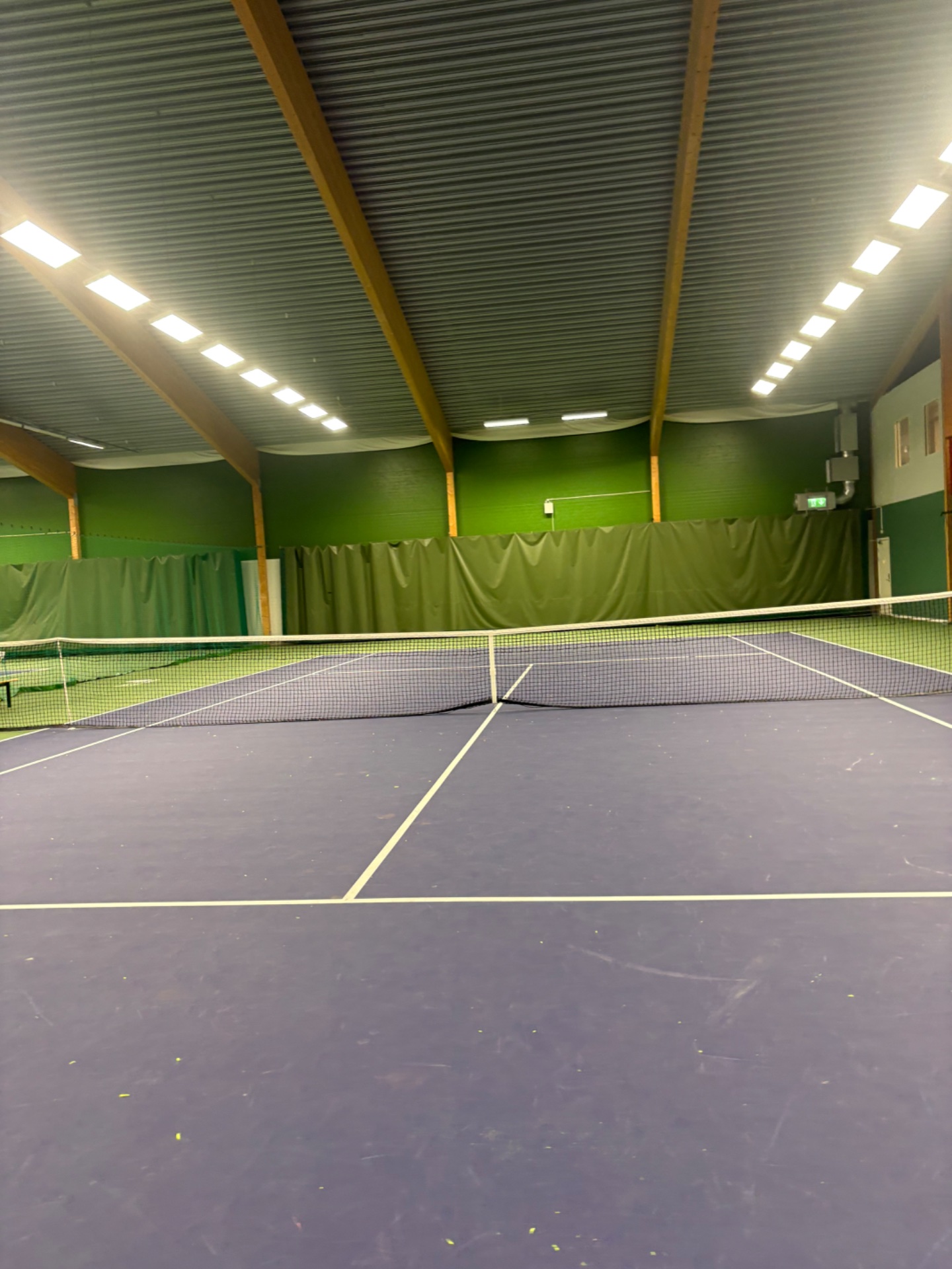 An indoor tennis court session! Tennis is a dynamic cardio workout that combines explosive movement, agility, and endurance as you chase the ball across the court.