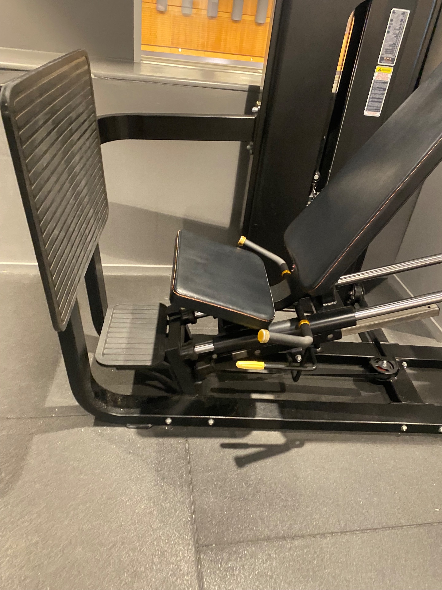 A leg press machine set up in a gym, ready for lower body strength training. This piece of equipment is perfect for targeting the quads, hamstrings, and glutes with resistance exercise.