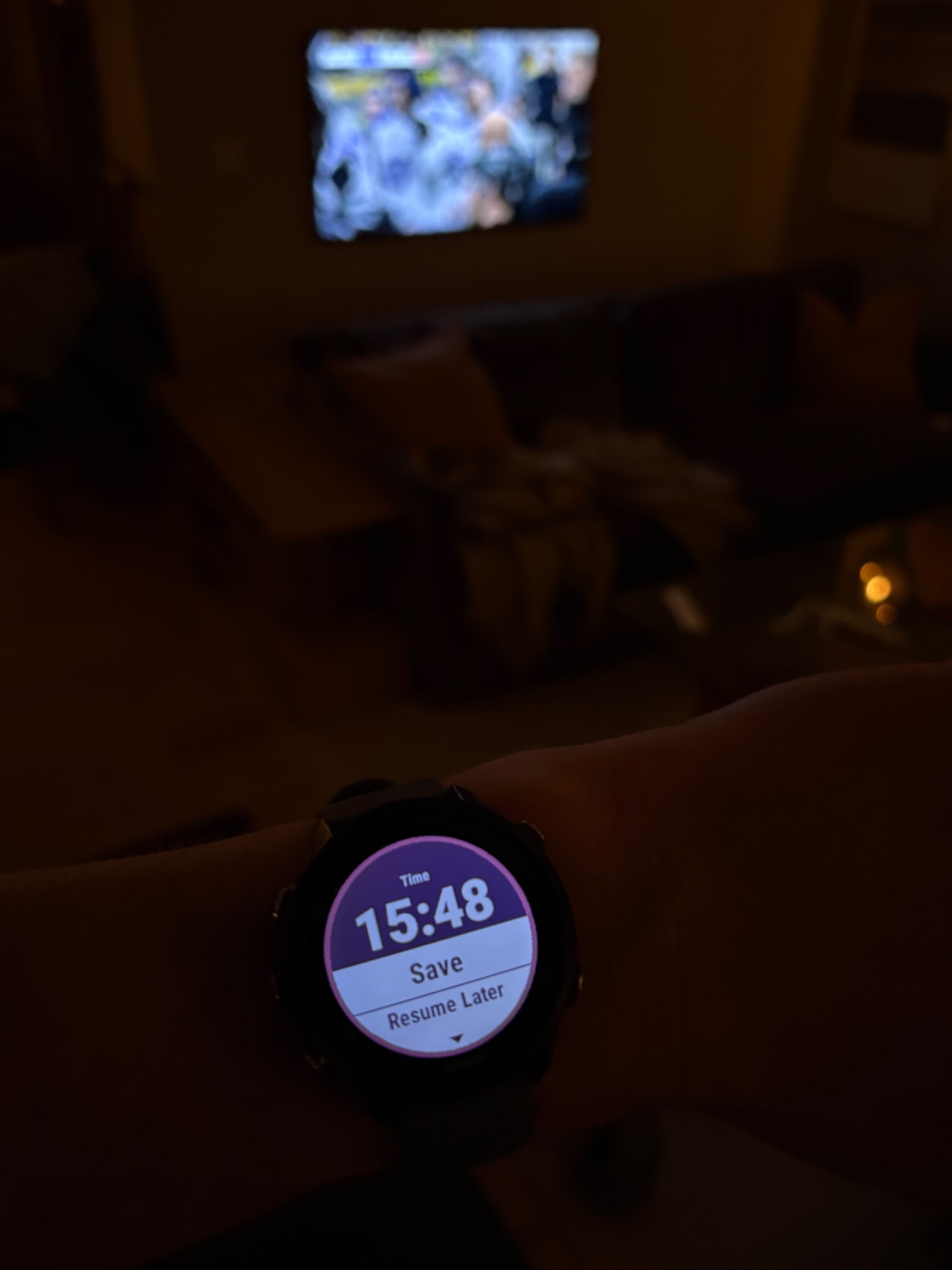 A fitness watch showing 15:48 of elapsed workout time with save and resume options displayed, indicating an active or recently paused cardio session being tracked.