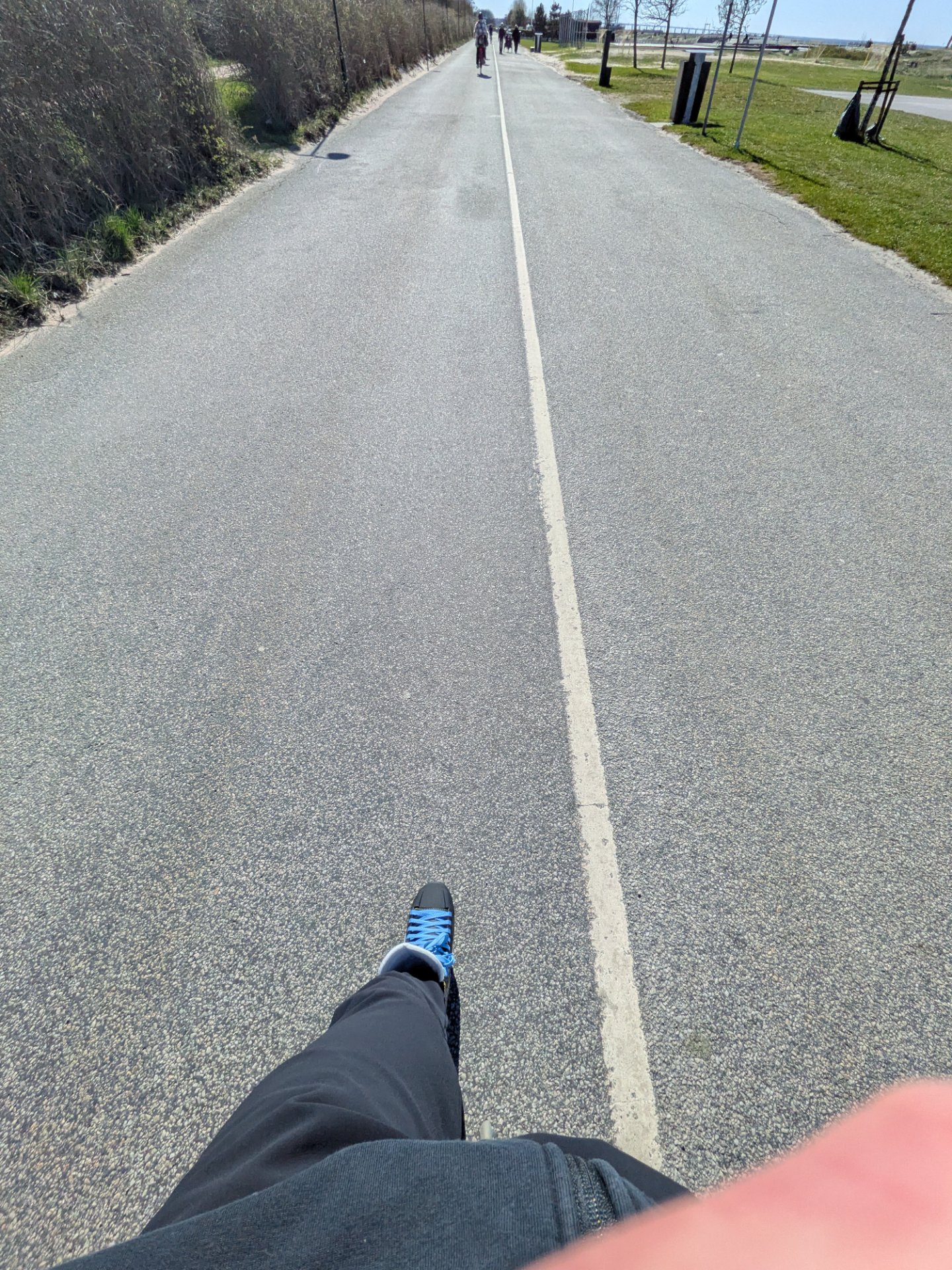 A scenic outdoor skate home from the office on a paved path with beautiful open fields and greenery. Perfect for building endurance while enjoying fresh air and natural surroundings!