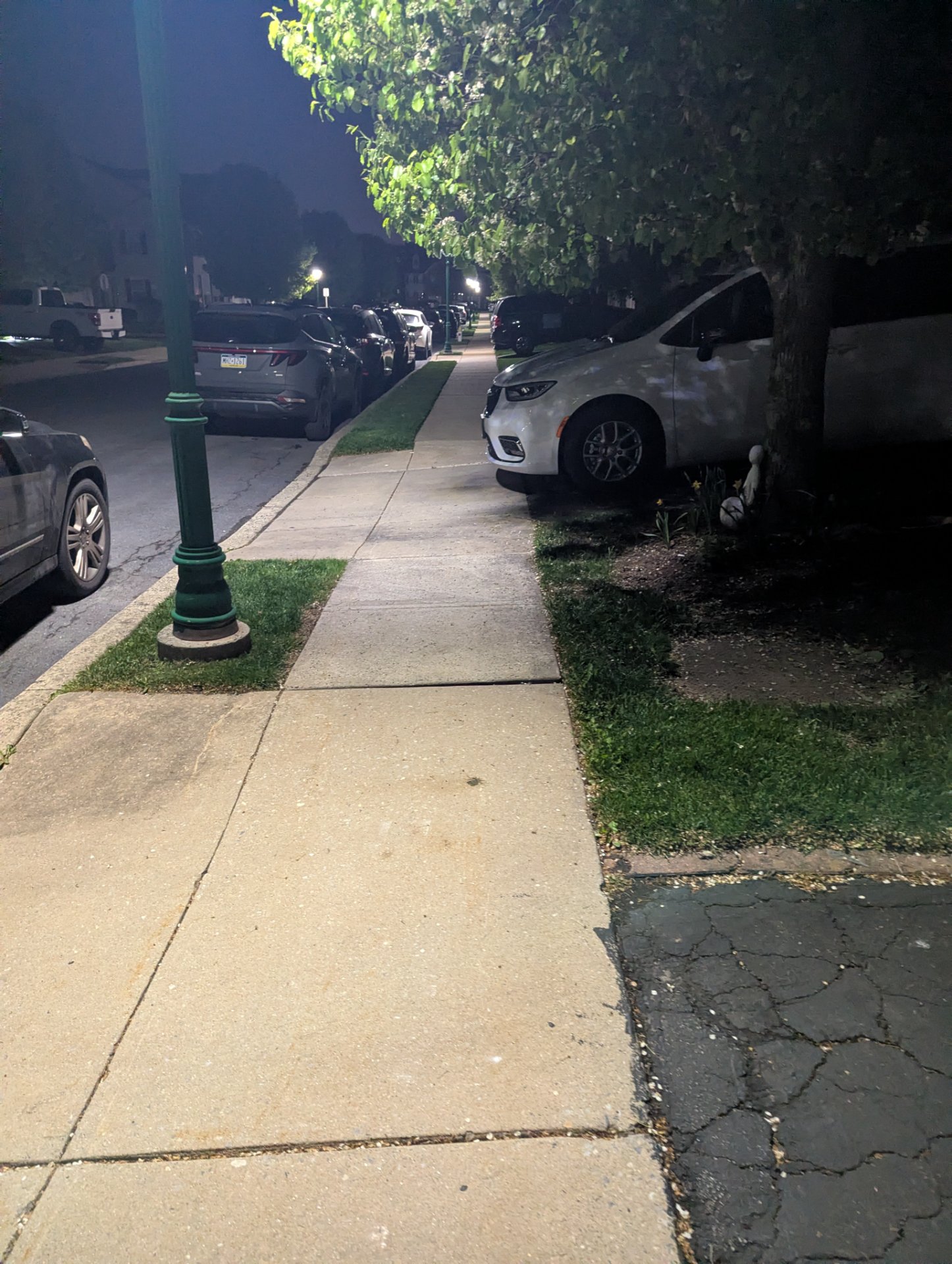 This image shows a suburban street scene with parked cars and sidewalks, which does not depict any exercise activity or workout.