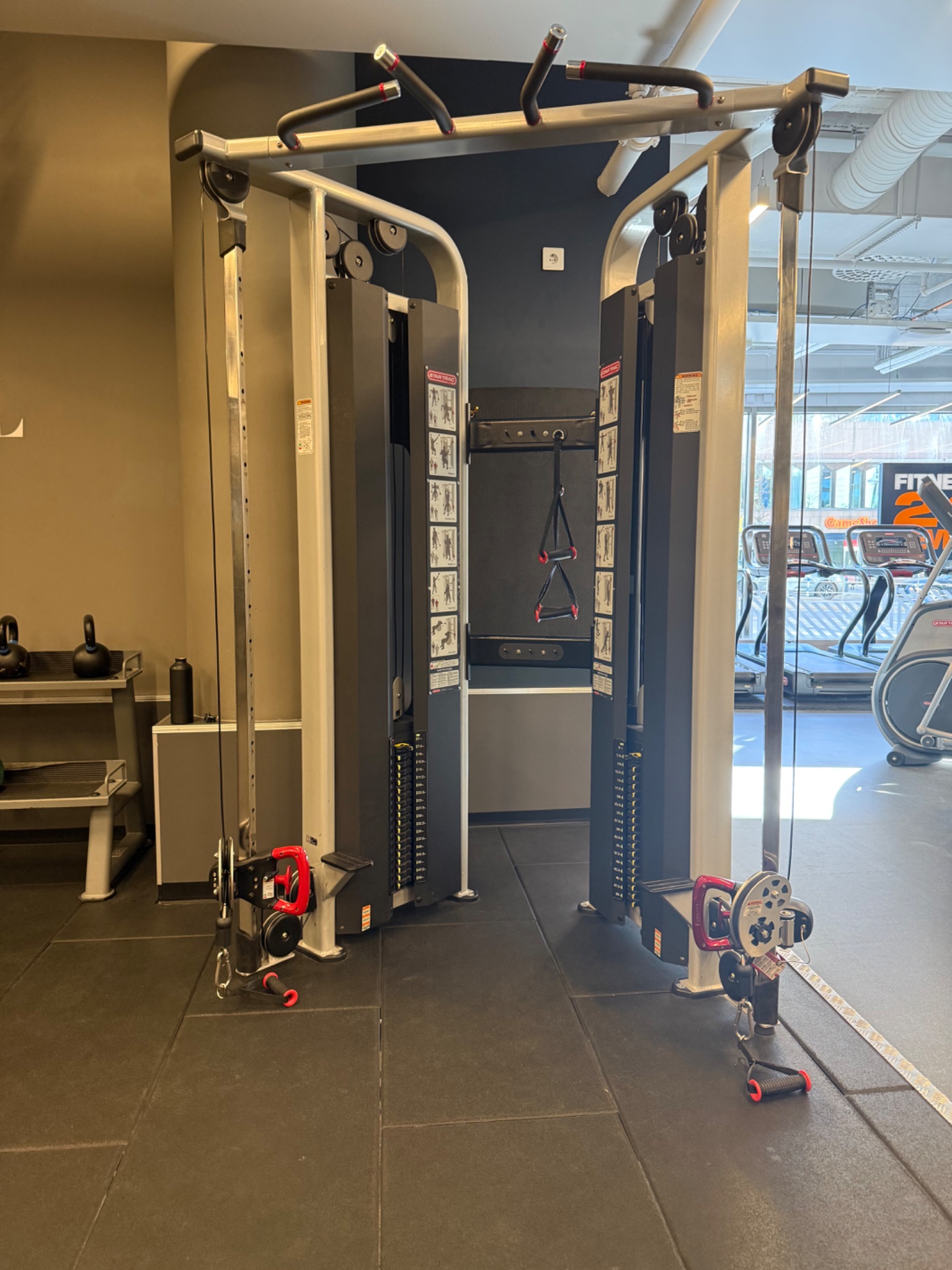 A functional strength training setup featuring advanced cable machines and resistance equipment in a modern gym facility. Perfect for cable-based resistance training and targeted muscle work!