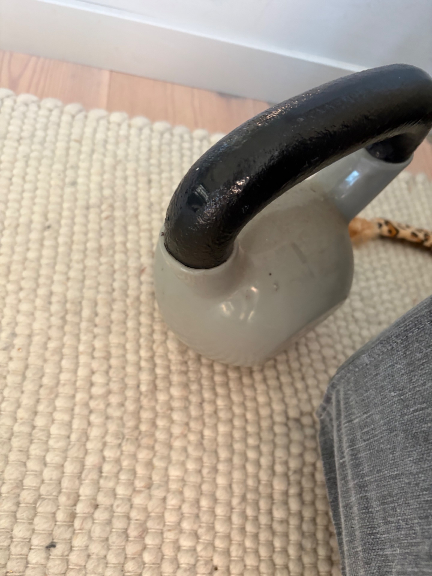 A kettlebell workout session! This close-up of a kettlebell shows the classic strength training tool ready for some intense resistance work.