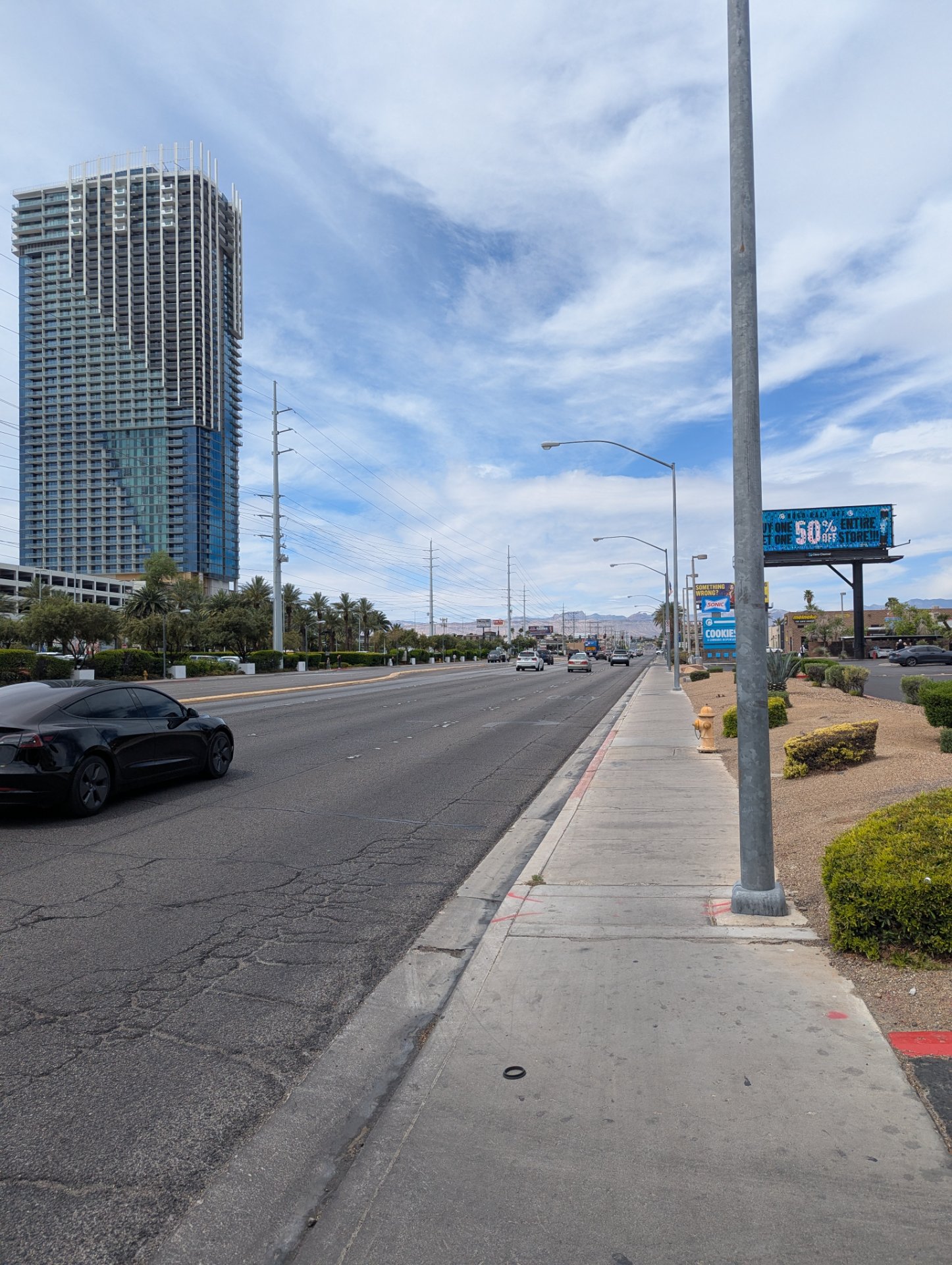 Urban walking or running workout along a city street with a clear sidewalk and outdoor scenery. Perfect for a steady-paced cardio session in an urban environment.