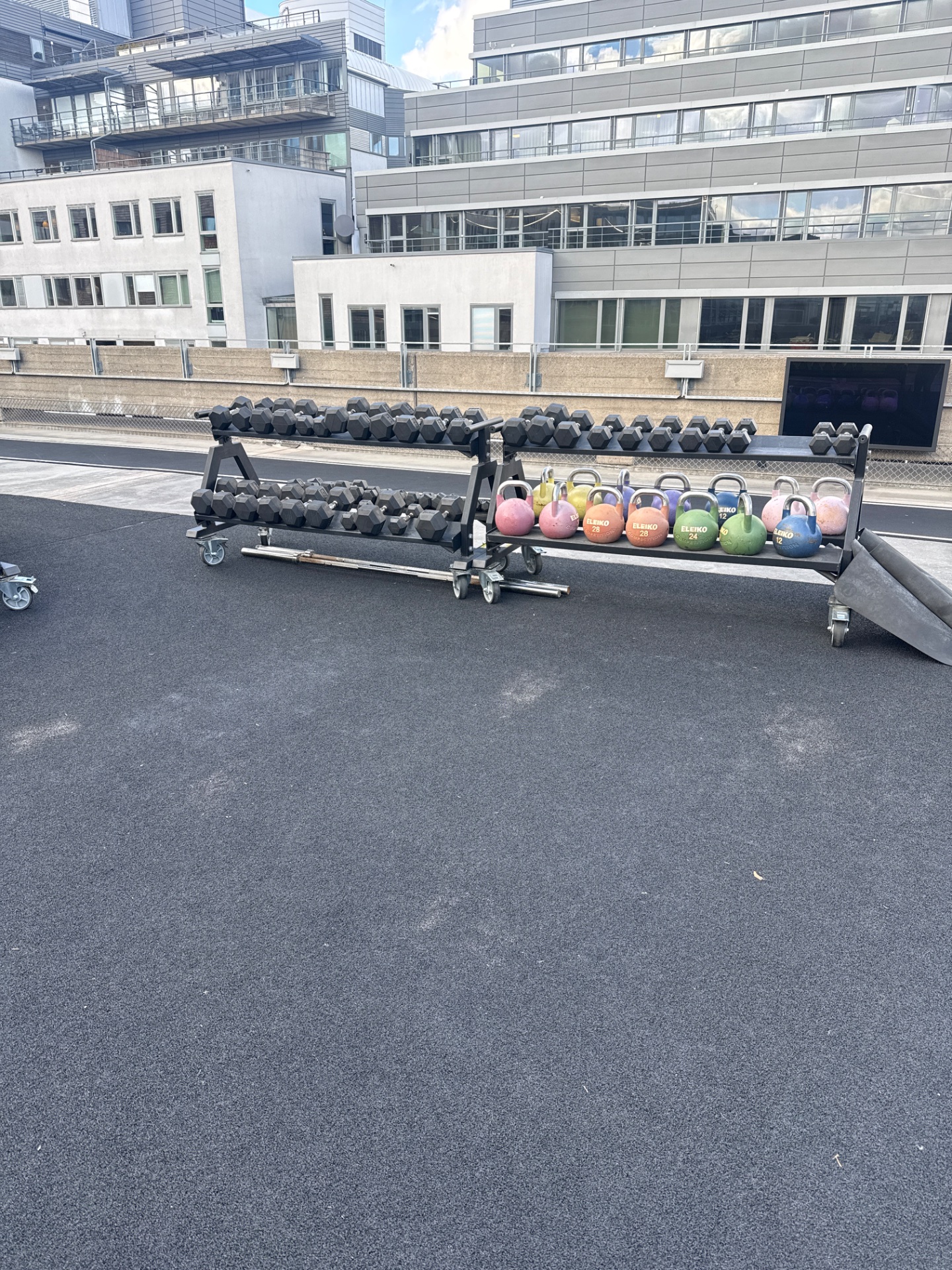 A well-equipped gym facility featuring an impressive array of dumbbells and medicine balls organized on racks, ready for resistance training and strength conditioning workouts.