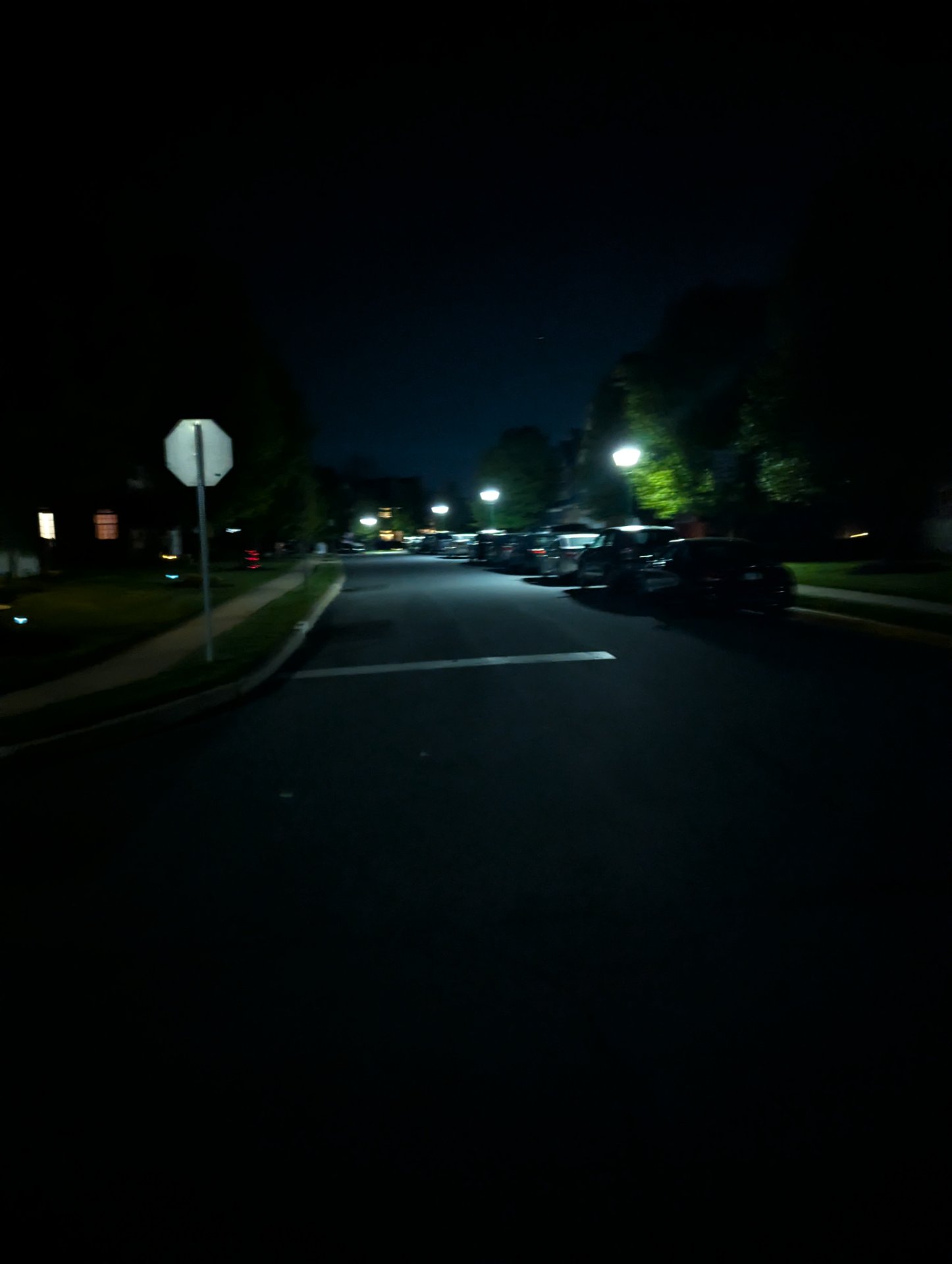 A nighttime outdoor run or walk through a parking lot area with street lighting. Great commitment to getting that cardio in after dark!