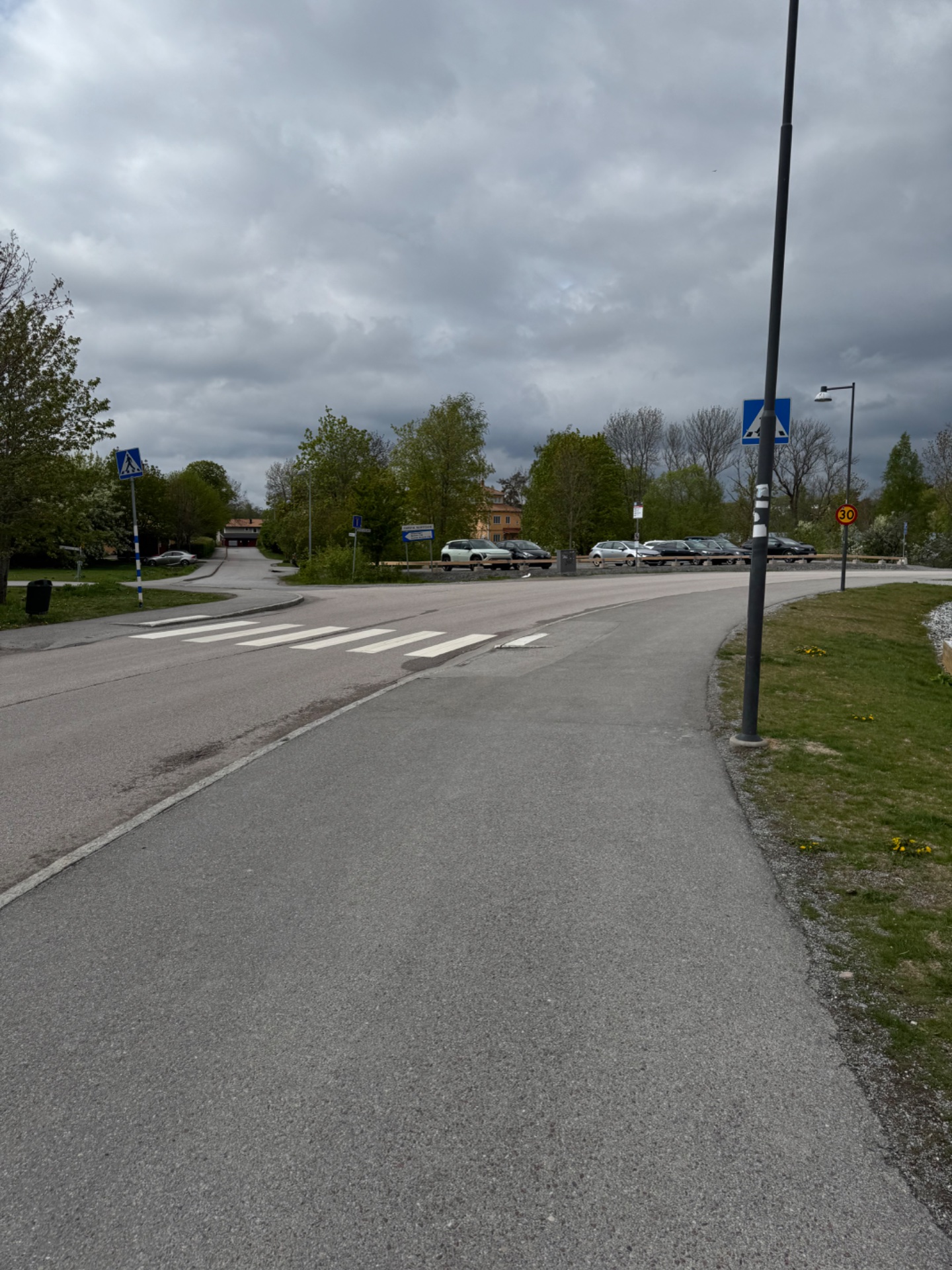Outdoor walking or running route through a suburban area with paved paths and pedestrian infrastructure. Great spot for a steady cardio session with natural surroundings!
