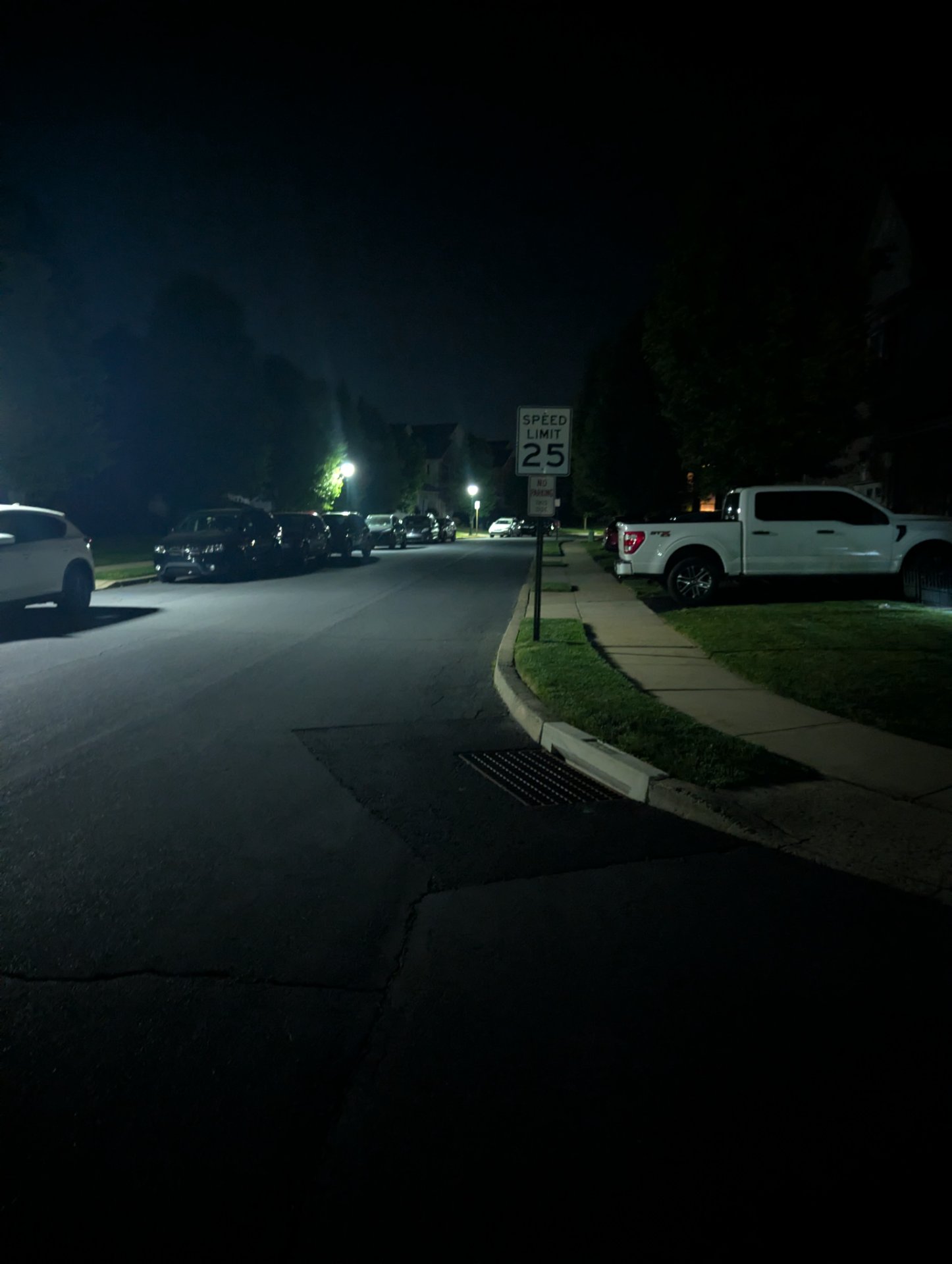 A nighttime street scene with parked cars and residential area—no clear exercise activity visible in this image.