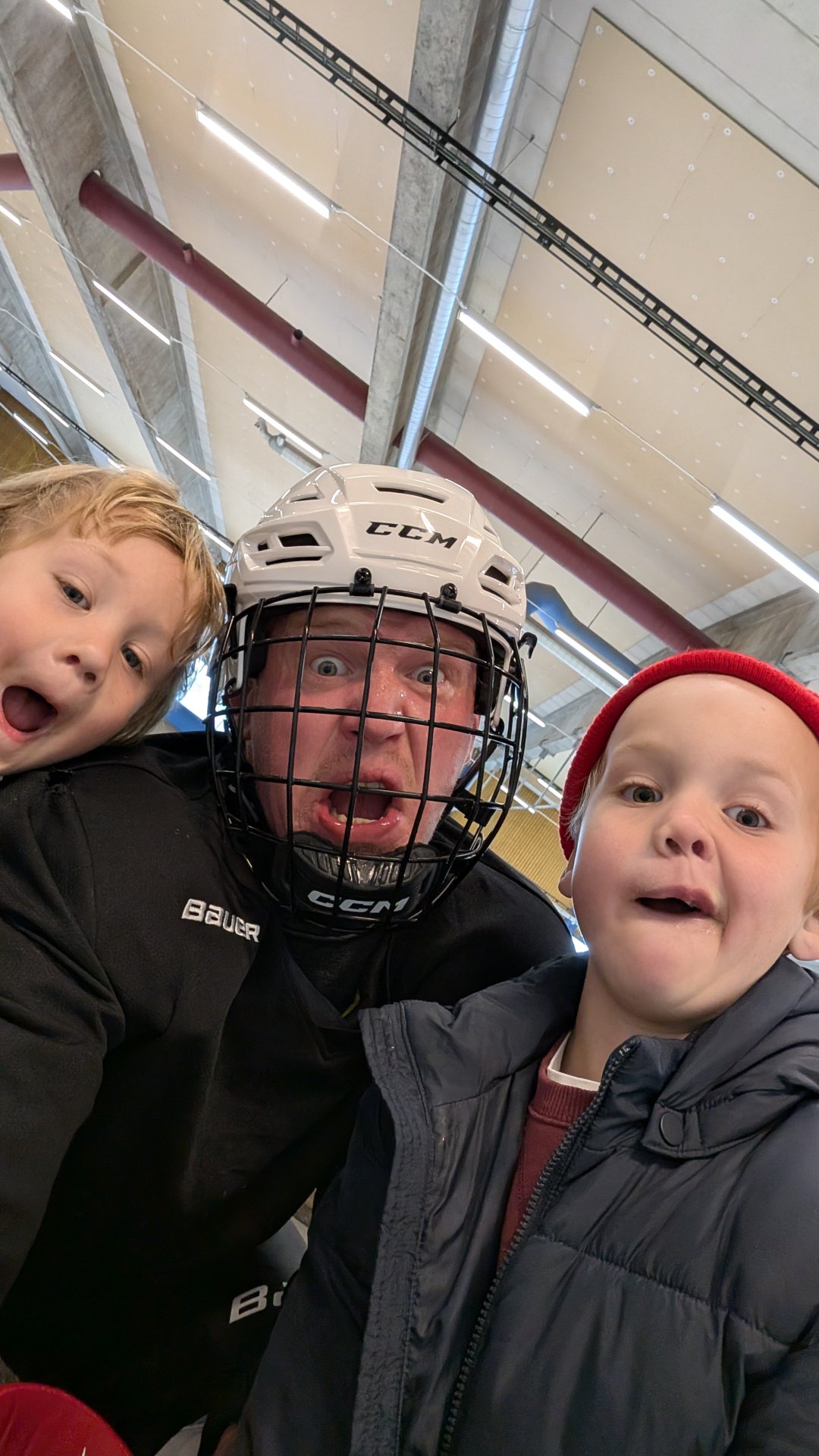 Ice hockey session at the rink! This is a fun family moment capturing hockey gear and the indoor skating environment where cardio conditioning is essential for the sport.