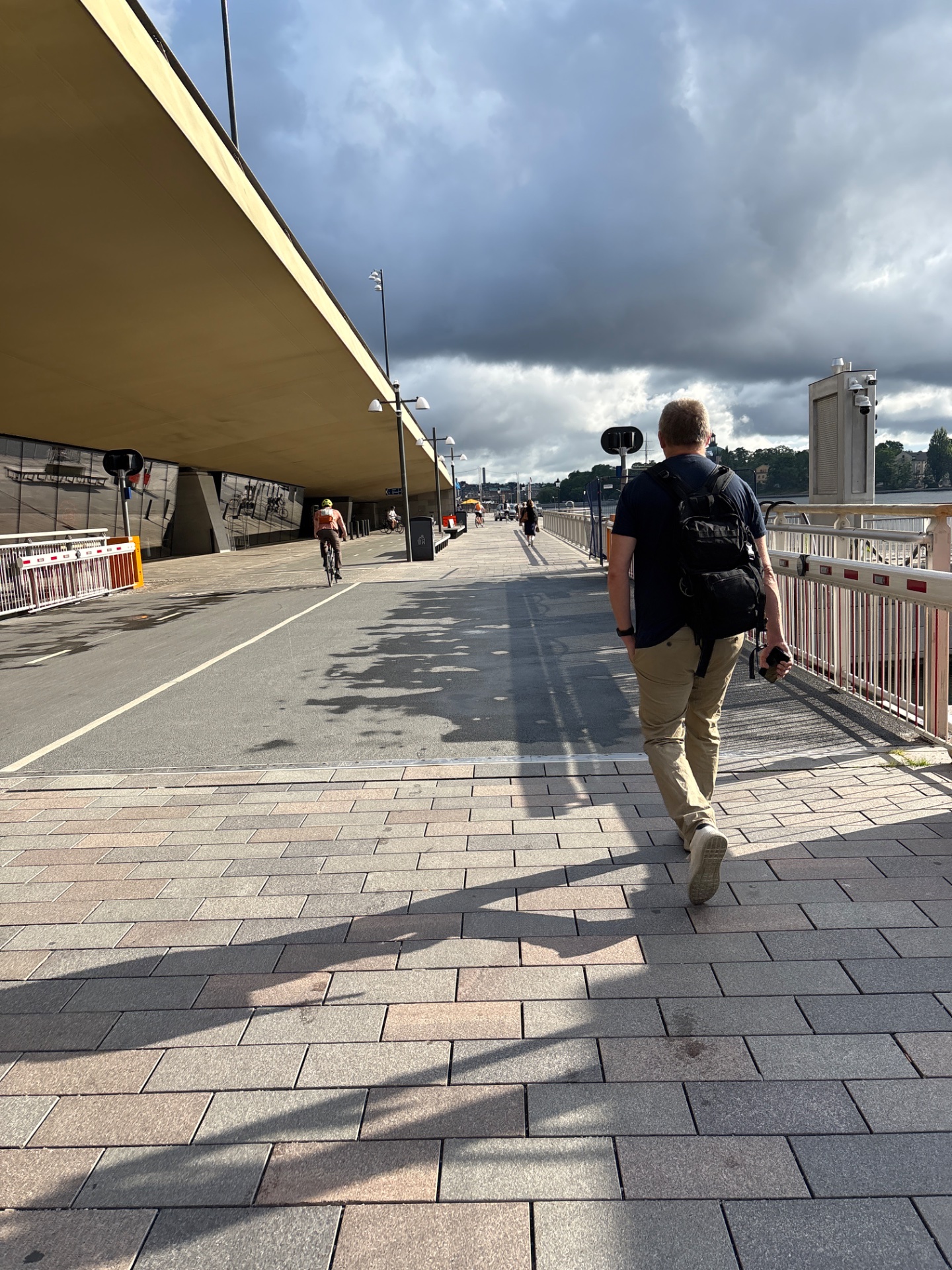 A great outdoor running session along a scenic waterfront promenade! The runner is enjoying a beautiful day with cyclists and other active people, getting in some solid cardio exercise in an inspiring urban setting.